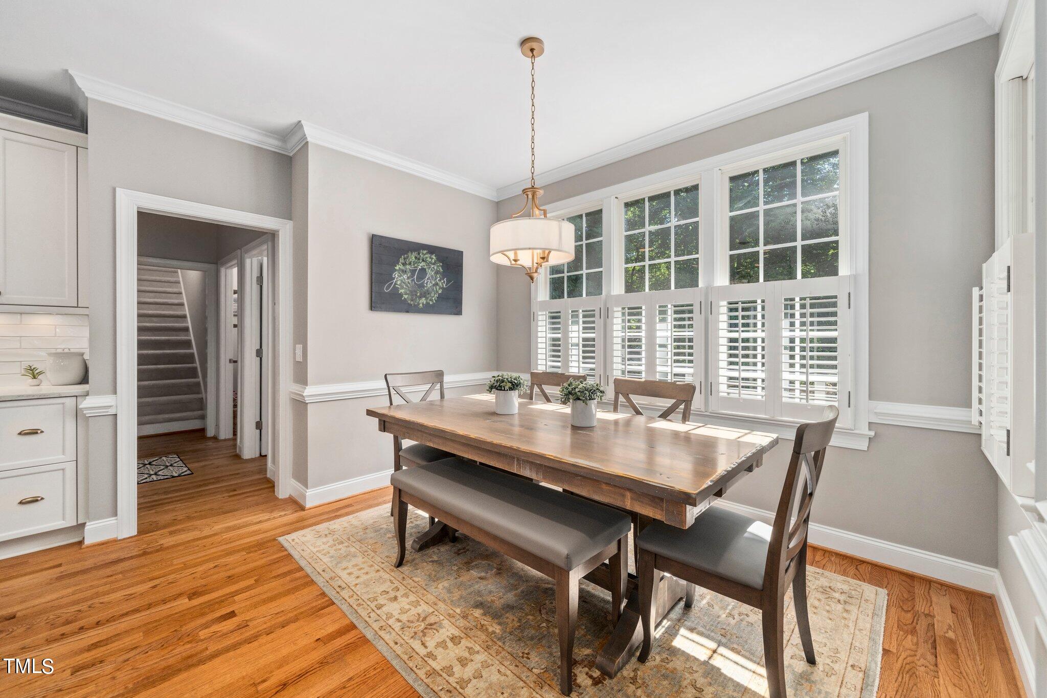 109 Chilcott Lane Apex, NC 27502 - Photo 9 of 34 a dining room with a table or chairs and a wooden floor