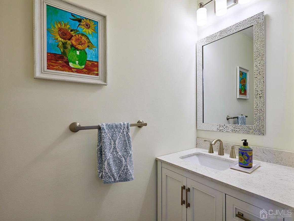 26 Glacier Drive Howell, NJ 07731 - Photo 12 of 31 a bathroom with a granite countertop sink a mirror and vanity