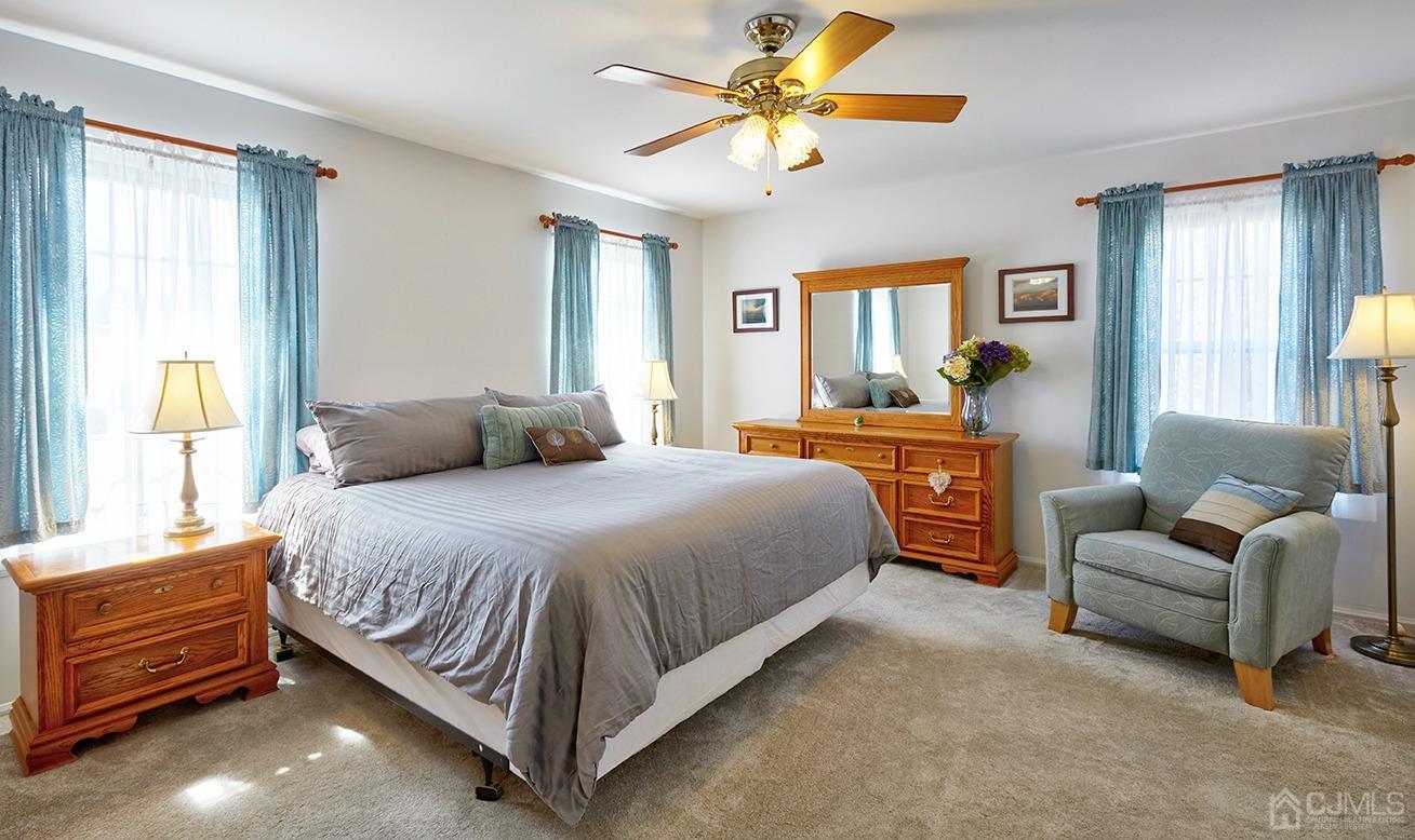 26 Glacier Drive Howell, NJ 07731 - Photo 14 of 31 a spacious bedroom with a bed and window