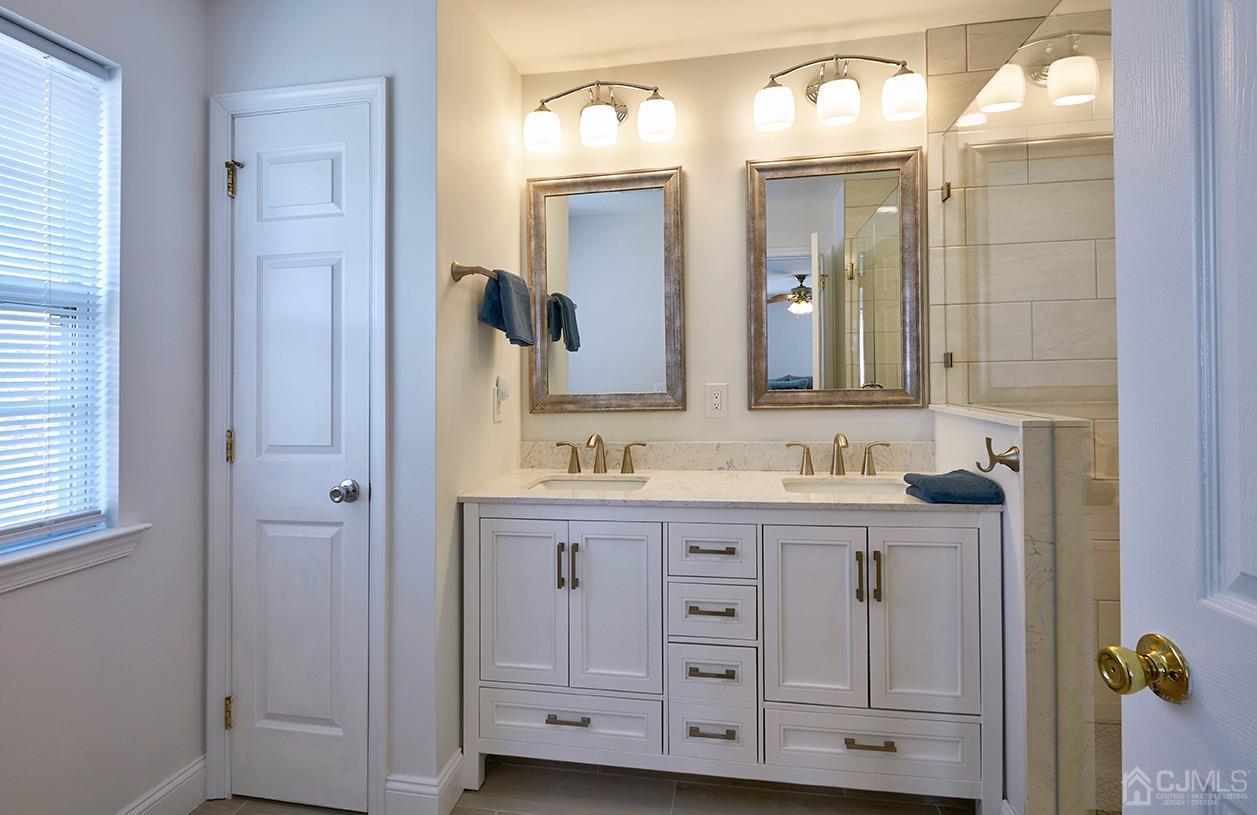 26 Glacier Drive Howell, NJ 07731 - Photo 17 of 31 a bathroom with a granite countertop sink vanity and mirror