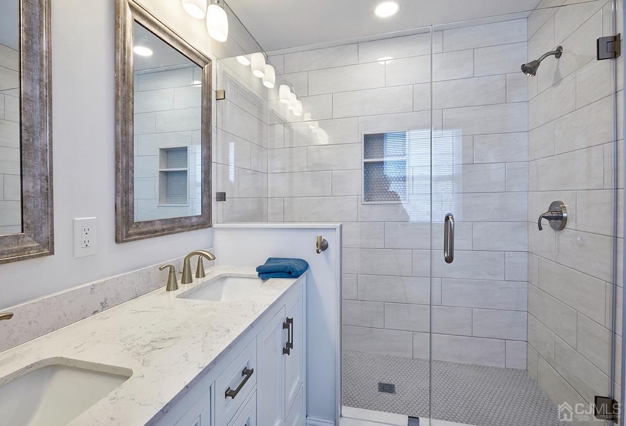 26 Glacier Drive Howell, NJ 07731 - Photo 18 of 31 a bathroom with a sink shower and a mirror