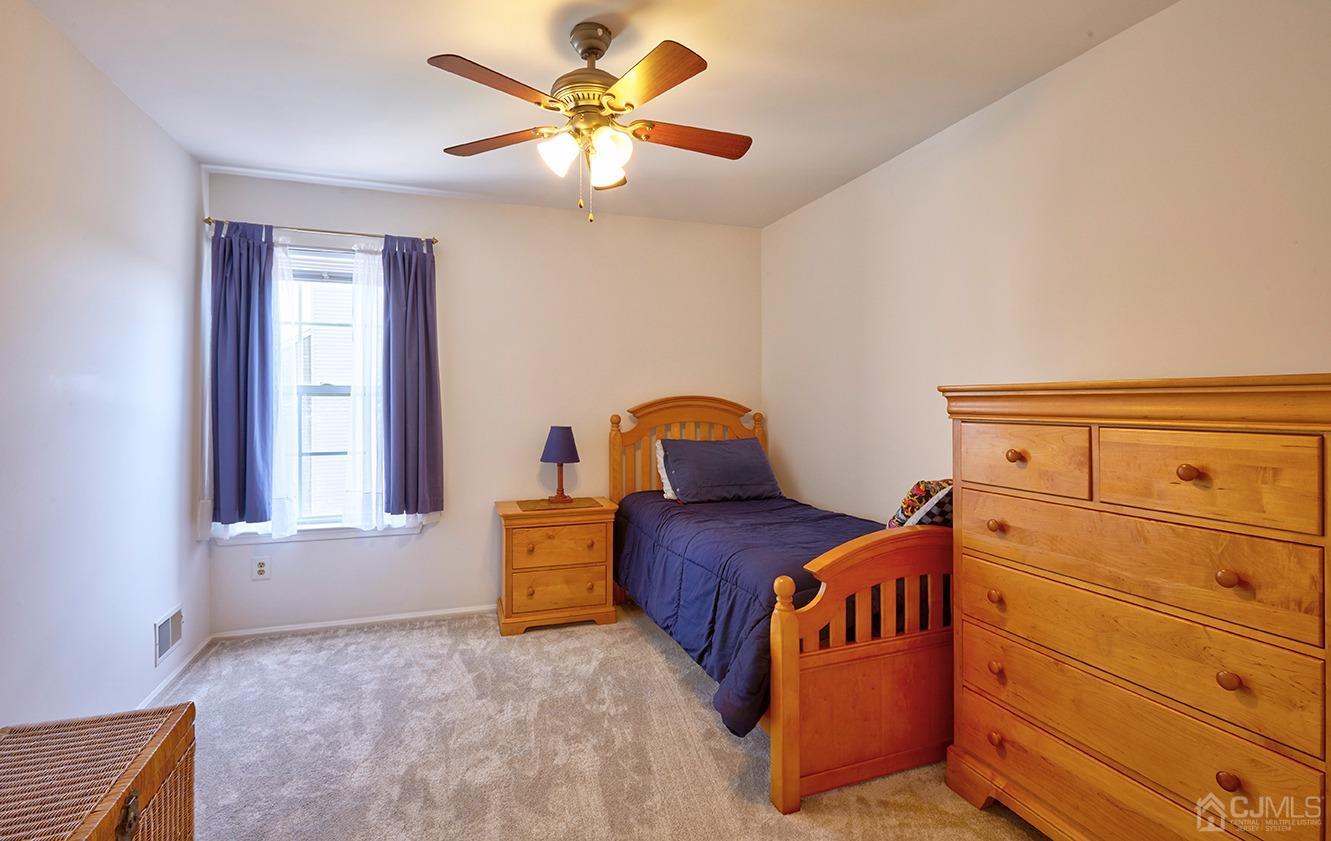 26 Glacier Drive Howell, NJ 07731 - Photo 19 of 31 a bedroom with a bed and window