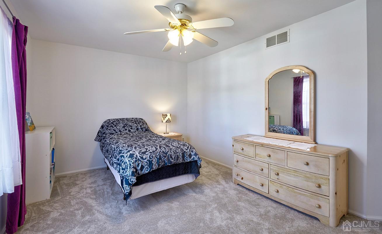 26 Glacier Drive Howell, NJ 07731 - Photo 23 of 31 a bedroom with a bed and a dresser