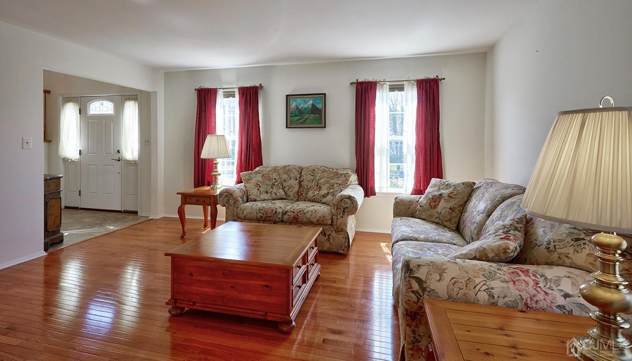 26 Glacier Drive Howell, NJ 07731 - Photo 4 of 31 a living room with furniture and a wooden floor