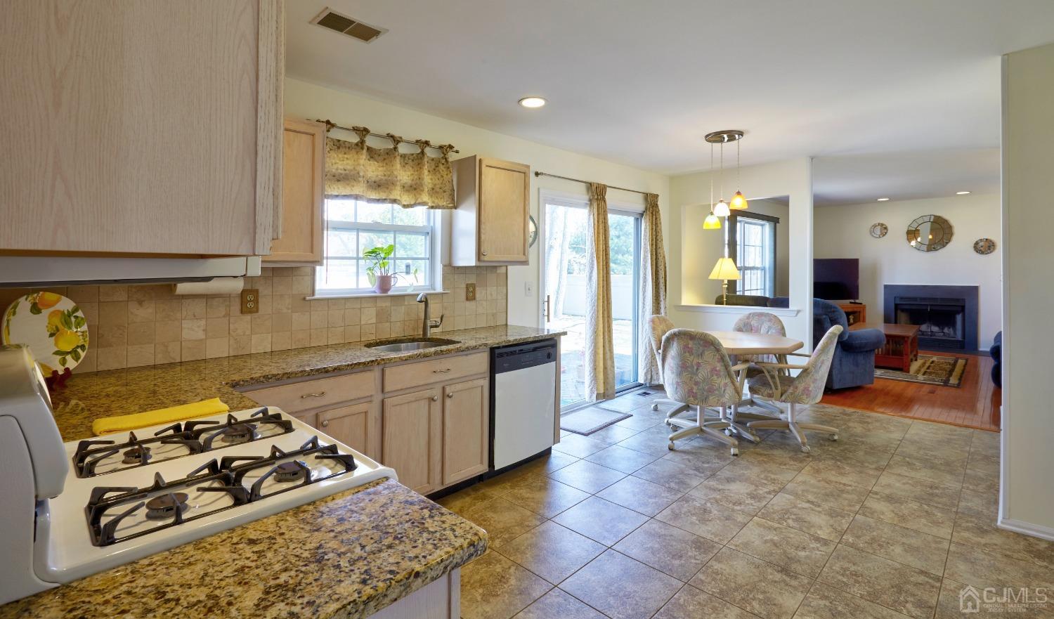26 Glacier Drive Howell, NJ 07731 - Photo 7 of 31 a kitchen with a sink a stove a counter top space and furniture