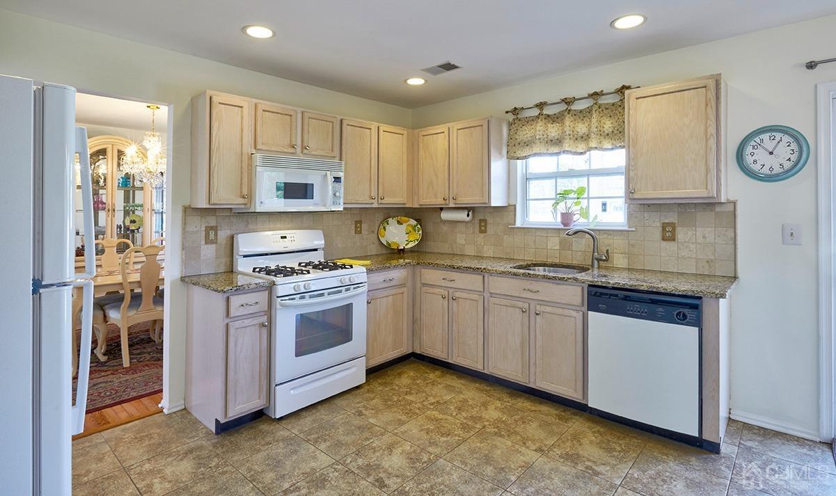 26 Glacier Drive Howell, NJ 07731 - Photo 8 of 31 a kitchen with a sink stove top oven and refrigerator