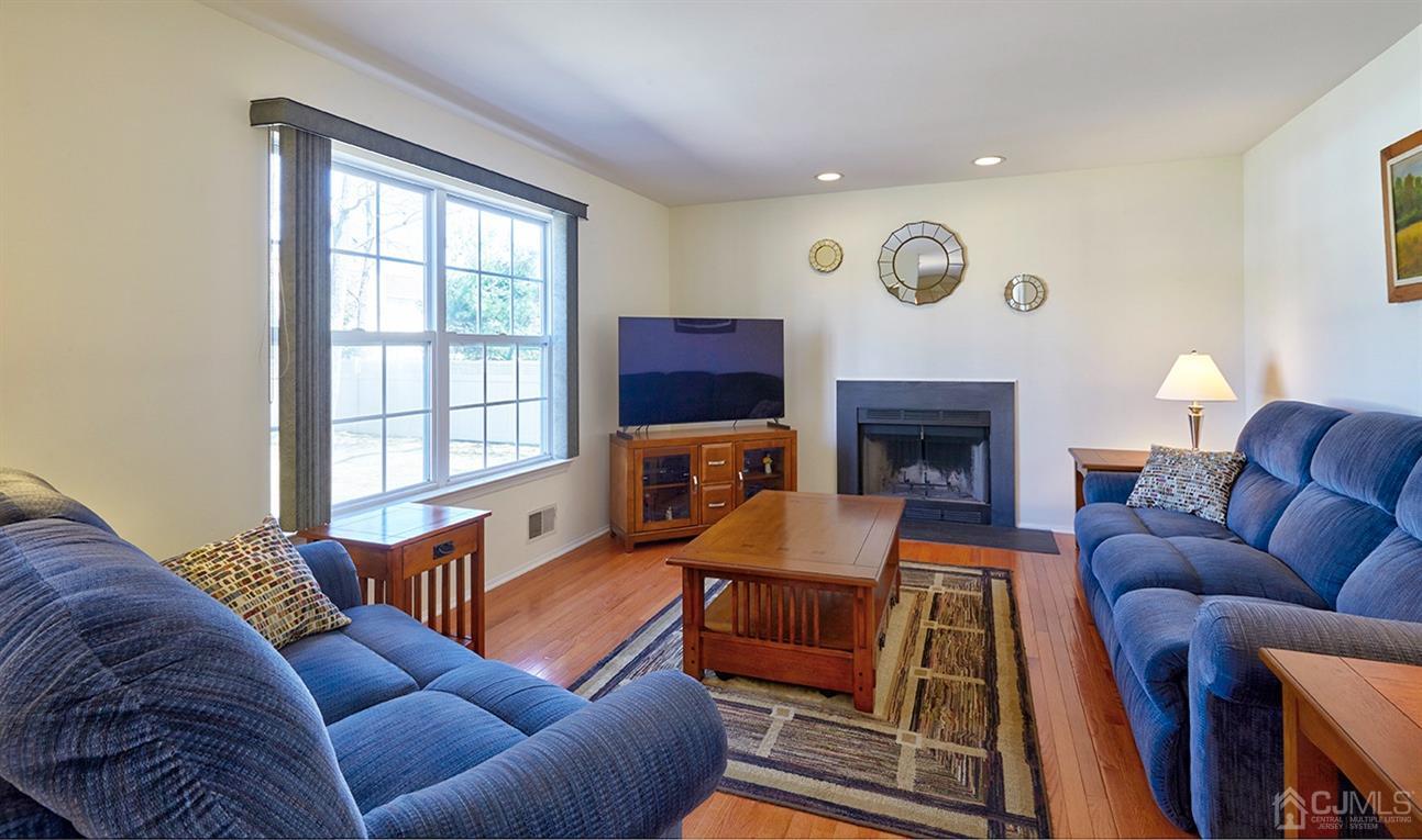 26 Glacier Drive Howell, NJ 07731 - Photo 10 of 31 a living room with furniture fireplace and a window