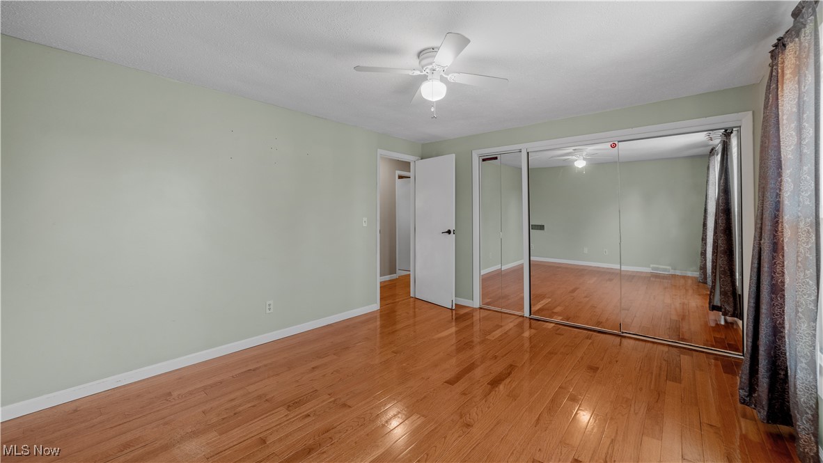 546 Twitchell Road Mansfield, OH 44903 - Photo 16 of 47 Unfurnished bedroom featuring ceiling fan, light wood-type flooring, and a closet