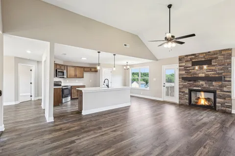a kitchen with stainless steel appliances kitchen island a white cabinets and wooden floor