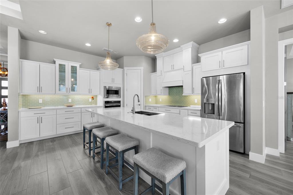 11949 Southwest 33 Lane Gainesville, FL 32608 - Photo 12 of 43 a kitchen with cabinets a sink appliances and wooden floor