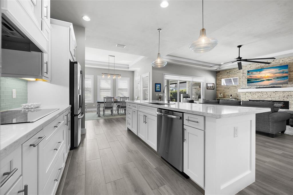 11949 Southwest 33 Lane Gainesville, FL 32608 - Photo 13 of 43 a kitchen with stainless steel appliances lots of counter top space and wooden floor