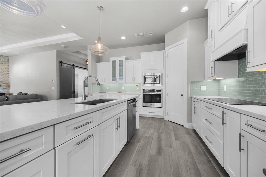 11949 Southwest 33 Lane Gainesville, FL 32608 - Photo 14 of 43 a large kitchen with granite countertop lots of counter space sink and cabinets
