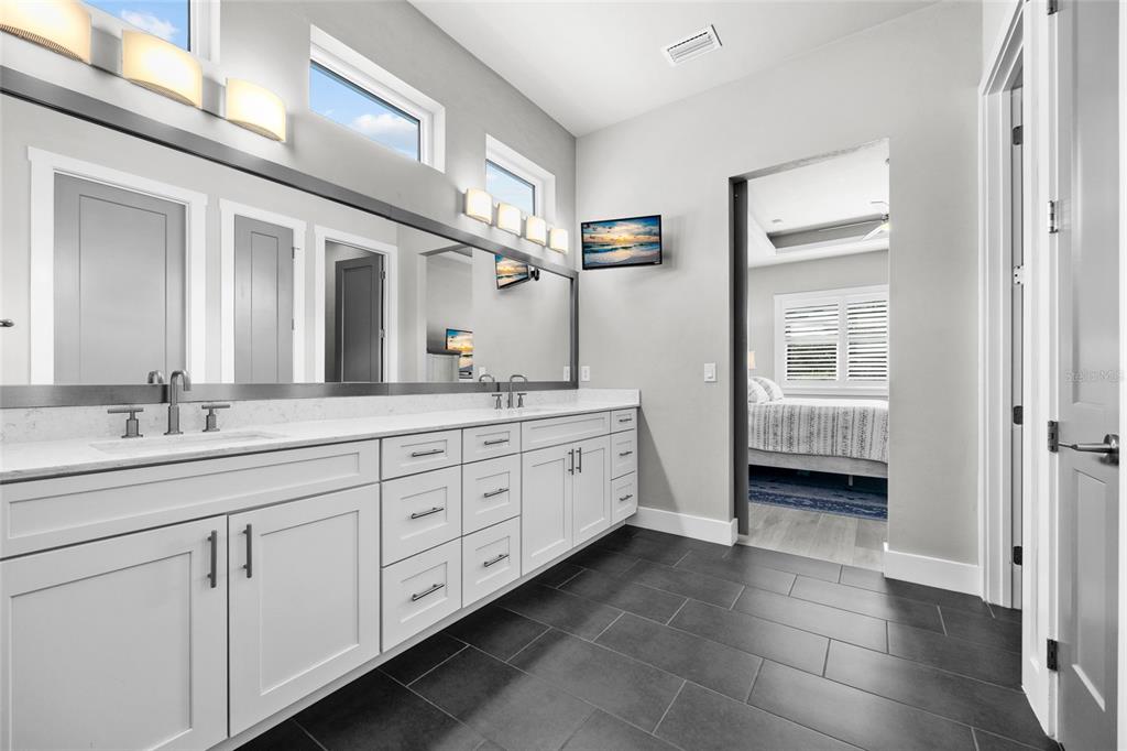 11949 Southwest 33 Lane Gainesville, FL 32608 - Photo 21 of 43 a spacious bathroom with double sink large mirror and a window