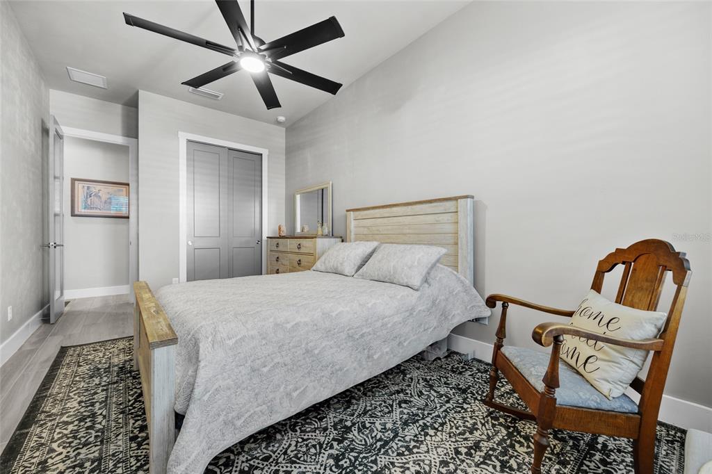 11949 Southwest 33 Lane Gainesville, FL 32608 - Photo 23 of 43 a bedroom with a bed a rug and chair