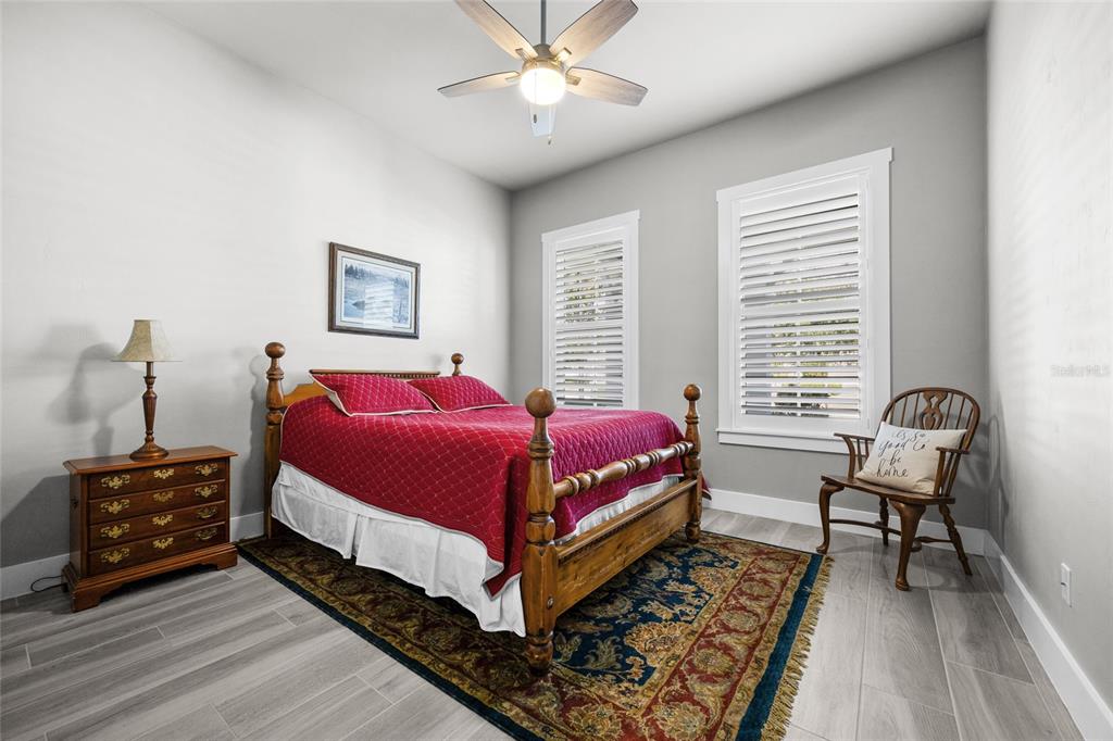 11949 Southwest 33 Lane Gainesville, FL 32608 - Photo 25 of 43 a spacious bedroom with a bed a dresser and a window