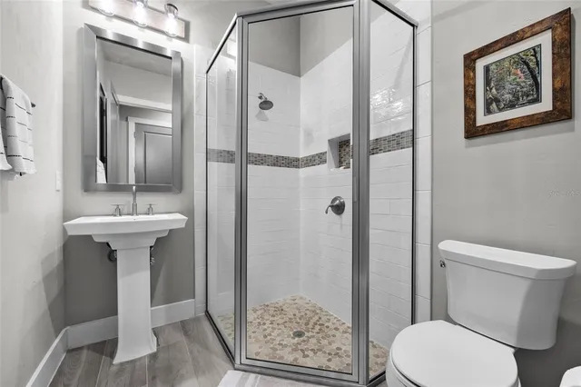 a bathroom with a sink toilet and shower