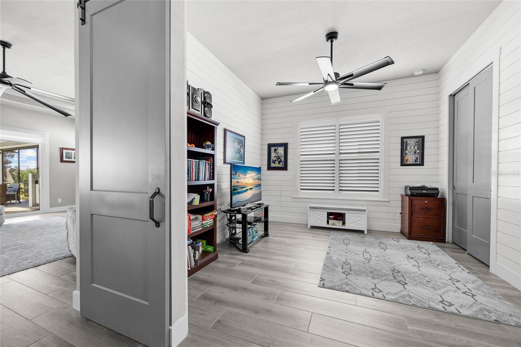 11949 Southwest 33 Lane Gainesville, FL 32608 - Photo 28 of 43 a living room with furniture and a flat screen tv