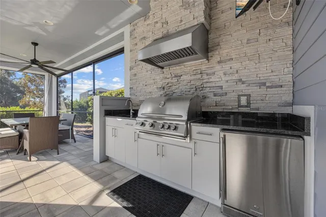 a kitchen with stainless steel appliances kitchen island a stove a sink and a refrigerator