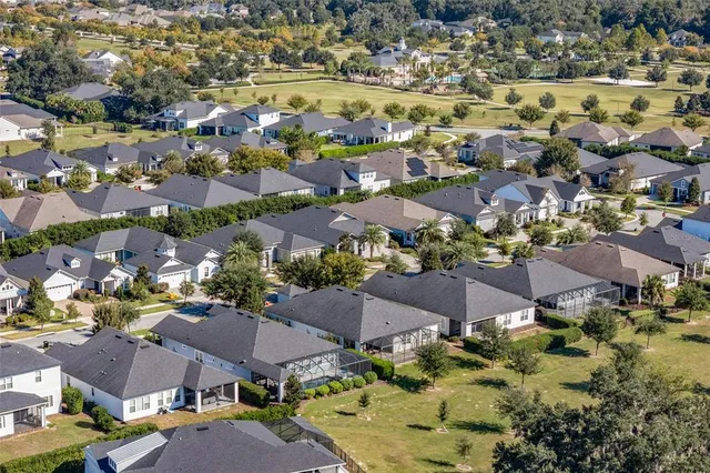 an aerial view of residential houses with outdoor space