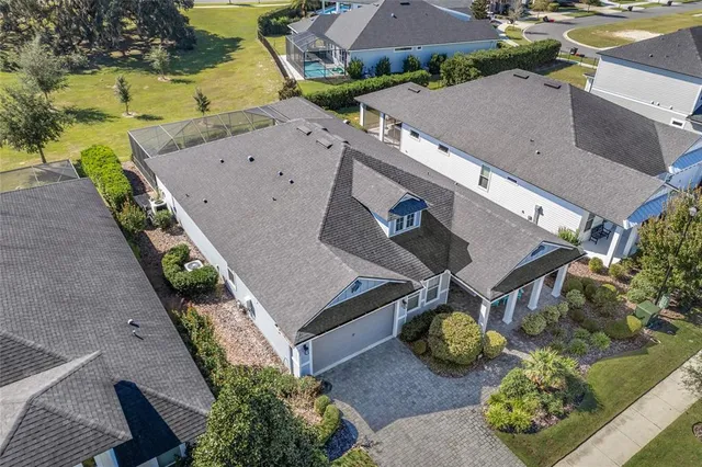 an aerial view of a house with a garden and pool