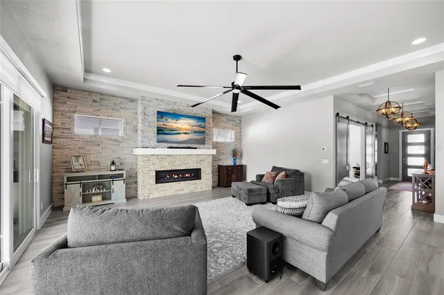 a living room with furniture a fireplace and a flat screen tv