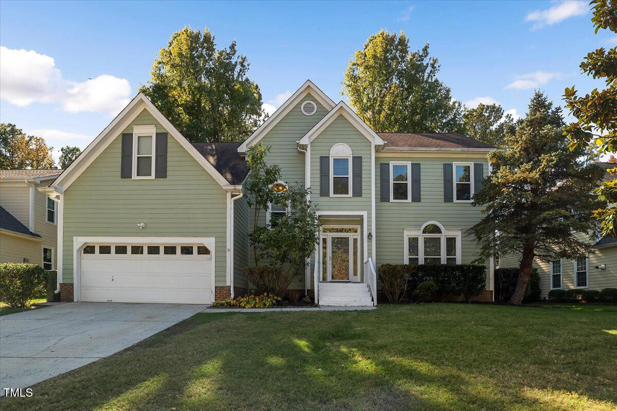a front view of a house with a yard and garage