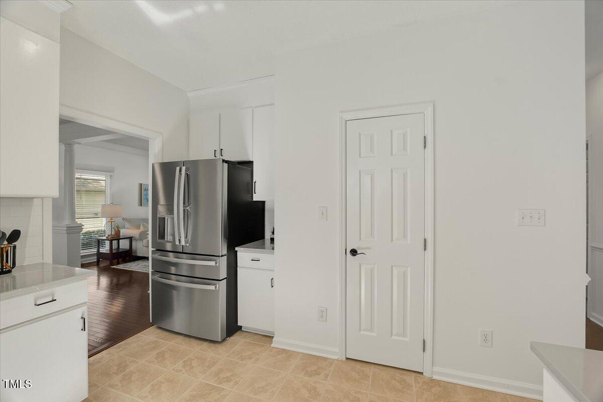 9813 Rockledge Drive Raleigh, NC 27617 - Photo 16 of 52 a kitchen with stainless steel appliances a refrigerator and cabinets