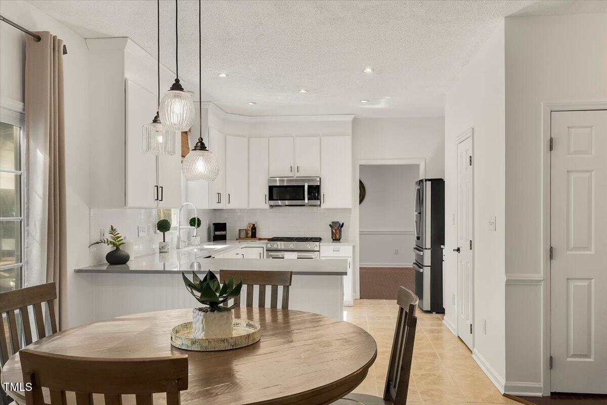 9813 Rockledge Drive Raleigh, NC 27617 - Photo 20 of 52 a view of a dining room with furniture