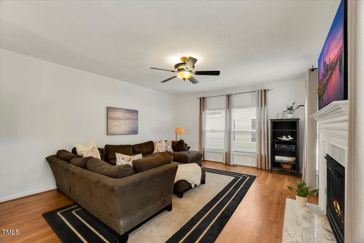 9813 Rockledge Drive Raleigh, NC 27617 - Photo 22 of 52 a living room with furniture and a fireplace