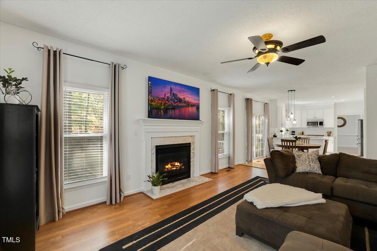 9813 Rockledge Drive Raleigh, NC 27617 - Photo 24 of 52 a living room with furniture and a fireplace