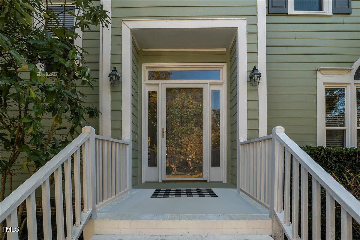 9813 Rockledge Drive Raleigh, NC 27617 - Photo 3 of 52 a front view of a house with a porch