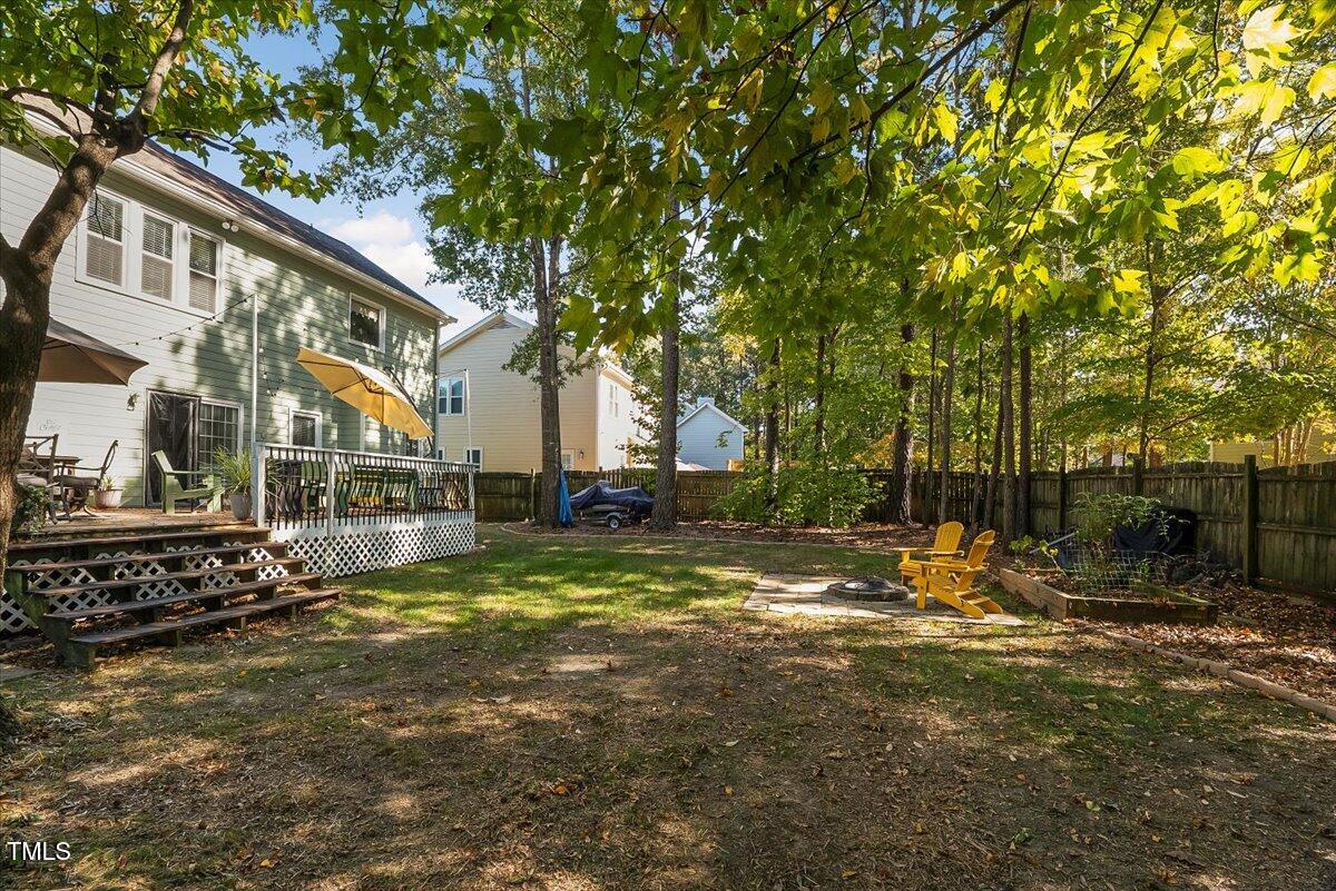 9813 Rockledge Drive Raleigh, NC 27617 - Photo 31 of 52 a view of backyard of house with green space