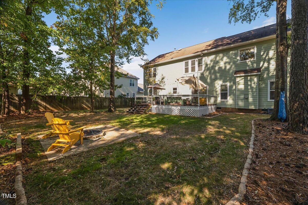 9813 Rockledge Drive Raleigh, NC 27617 - Photo 33 of 52 a backyard of a house with lots of green space