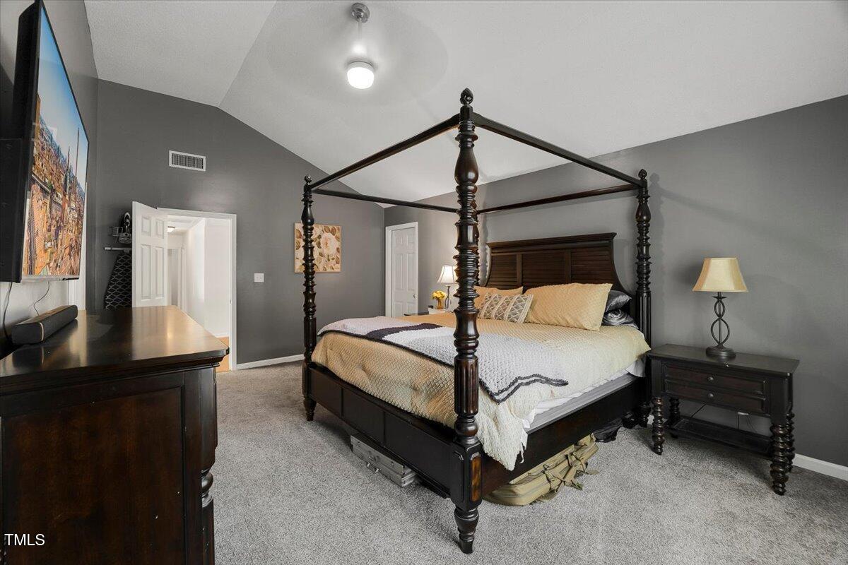 9813 Rockledge Drive Raleigh, NC 27617 - Photo 41 of 52 a bed room with a bed and a night stand