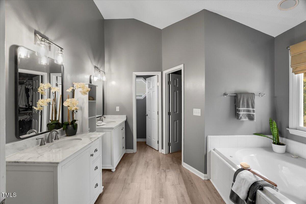 9813 Rockledge Drive Raleigh, NC 27617 - Photo 42 of 52 a large bathroom with a granite countertop double vanity sink a mirror and a shower