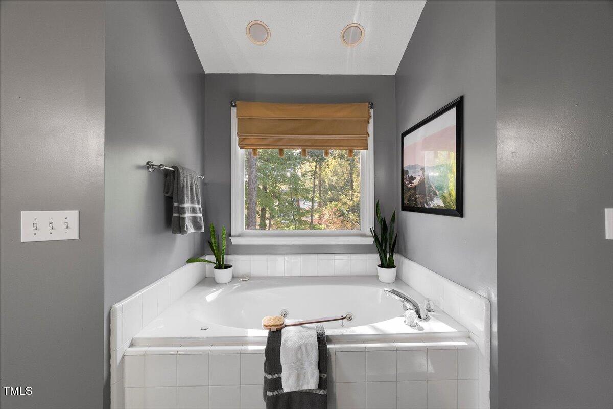 9813 Rockledge Drive Raleigh, NC 27617 - Photo 43 of 52 a bathroom with a sink and a bathtub