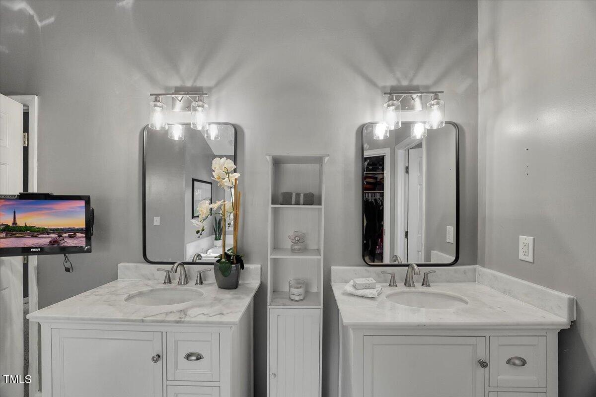 9813 Rockledge Drive Raleigh, NC 27617 - Photo 45 of 52 a bathroom with a sink double vanity and a mirror