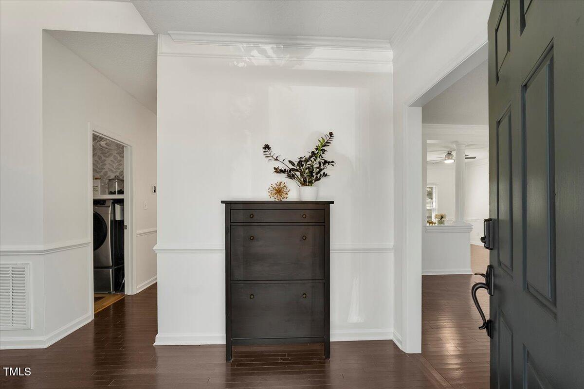 9813 Rockledge Drive Raleigh, NC 27617 - Photo 7 of 52 a view of a hallway with wooden floor and closet
