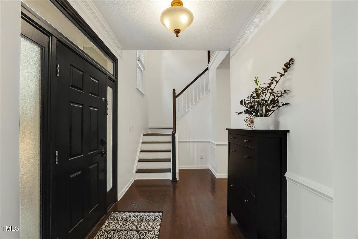 9813 Rockledge Drive Raleigh, NC 27617 - Photo 9 of 52 a view of entryway with wooden floor