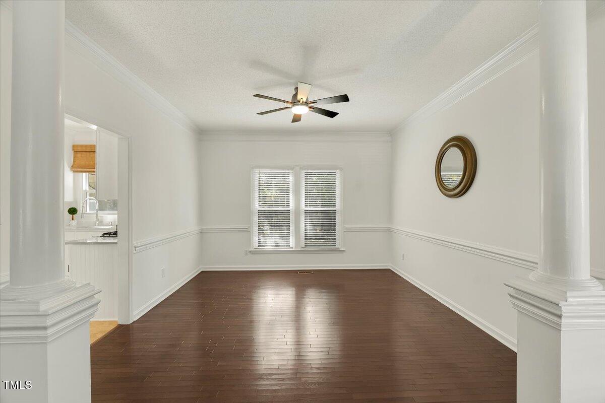 9813 Rockledge Drive Raleigh, NC 27617 - Photo 10 of 52 a view of empty room with wooden floor and fan