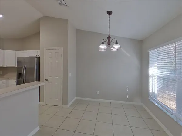 a kitchen with stainless steel appliances granite countertop a refrigerator and a stove
