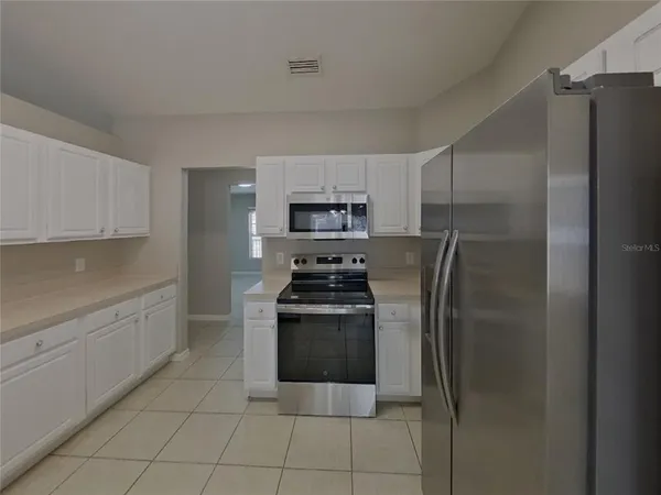 a kitchen with a refrigerator stove and microwave