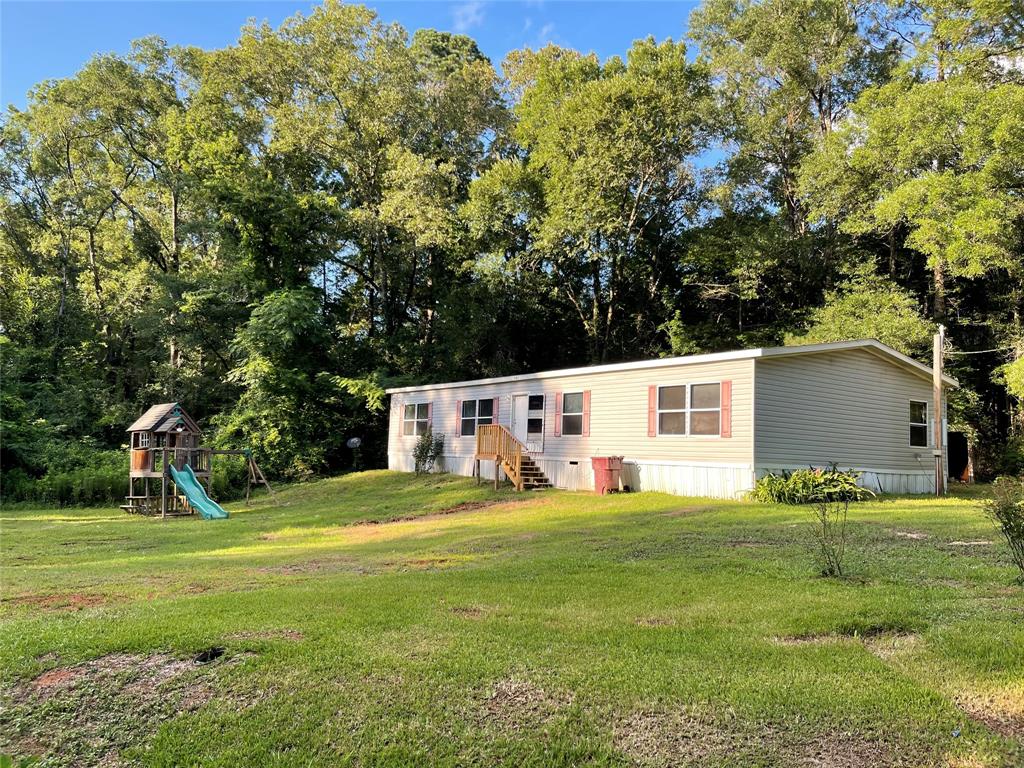 907 Ridge Road Castor, LA 71016 - Photo 1 of 25 a front view of a house with a yard and trees