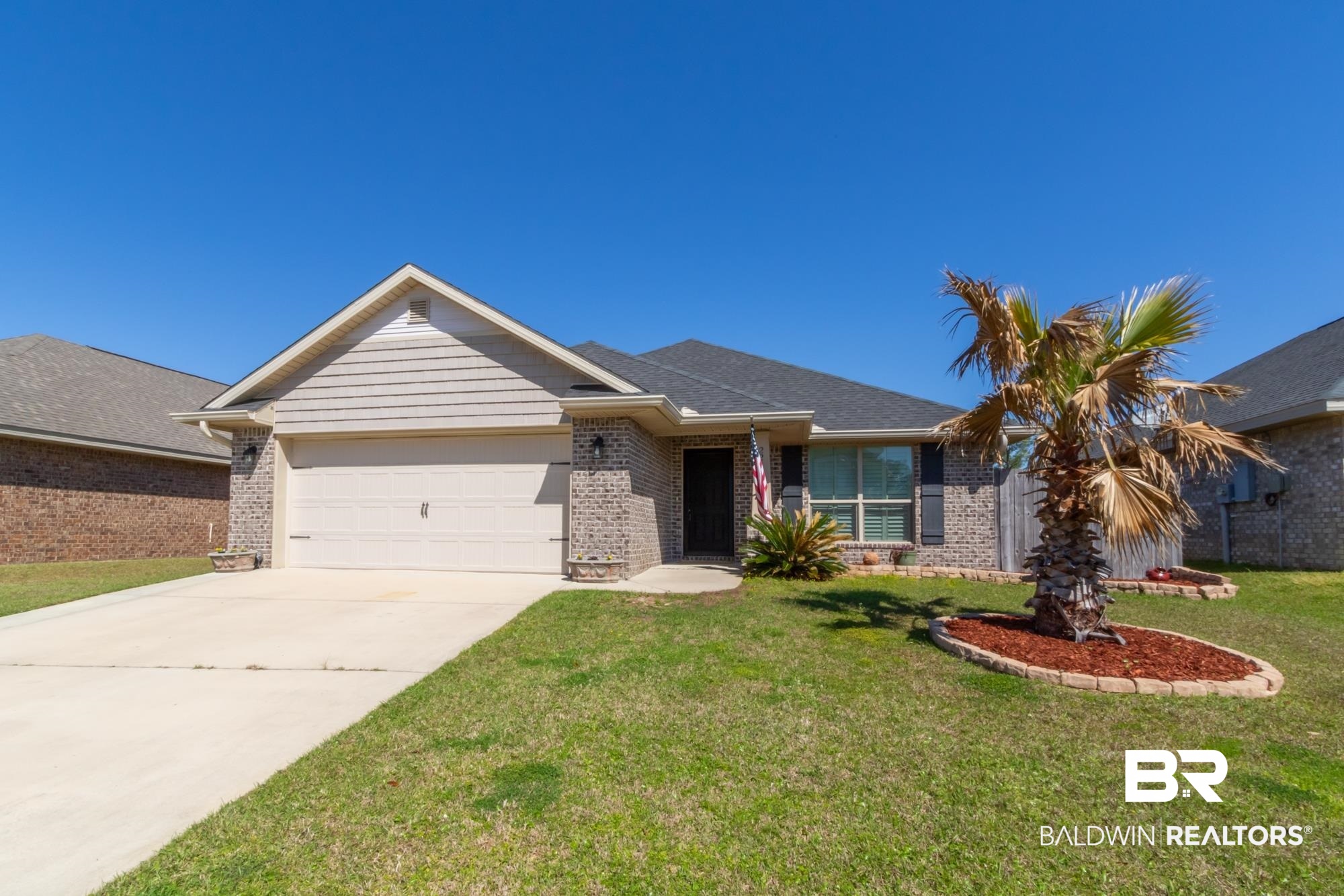 22641 Respite Lane Foley, AL 36535 - Photo 1 of 33 Ranch-style home with driveway, a front lawn, brick siding, and an attached garage