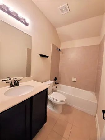 a bathroom with a double vanity sink toilet mirror and bathtub