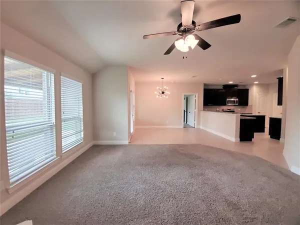 a view of a livingroom with a kitchen