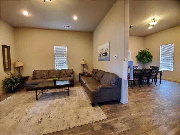 a living room with furniture and wooden floor
