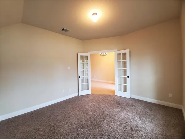a view of an empty room and a window