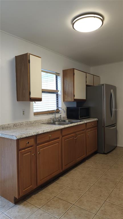 1737 Shady Ridge Court, Unit 231 Orlando, FL 32807 - Photo 11 of 30 a kitchen with stainless steel appliances granite countertop a sink stove and refrigerator