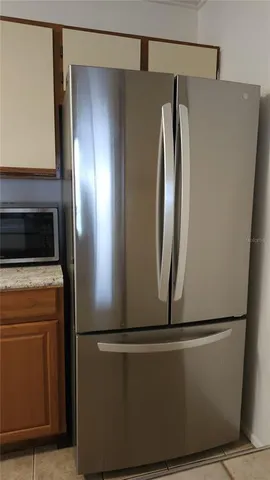 a view of a refrigerator in kitchen